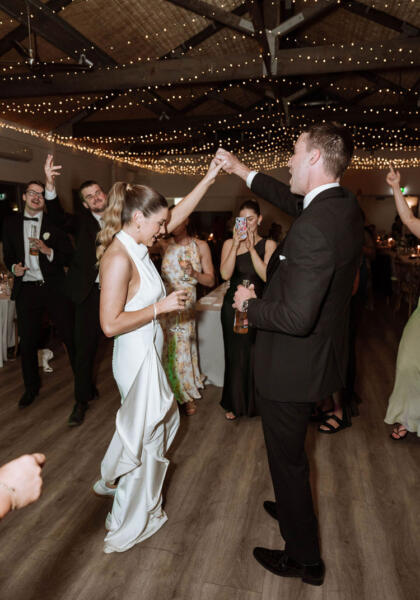 Bride and grooms first dance under fairy lights at Terindah Estate wedding reception