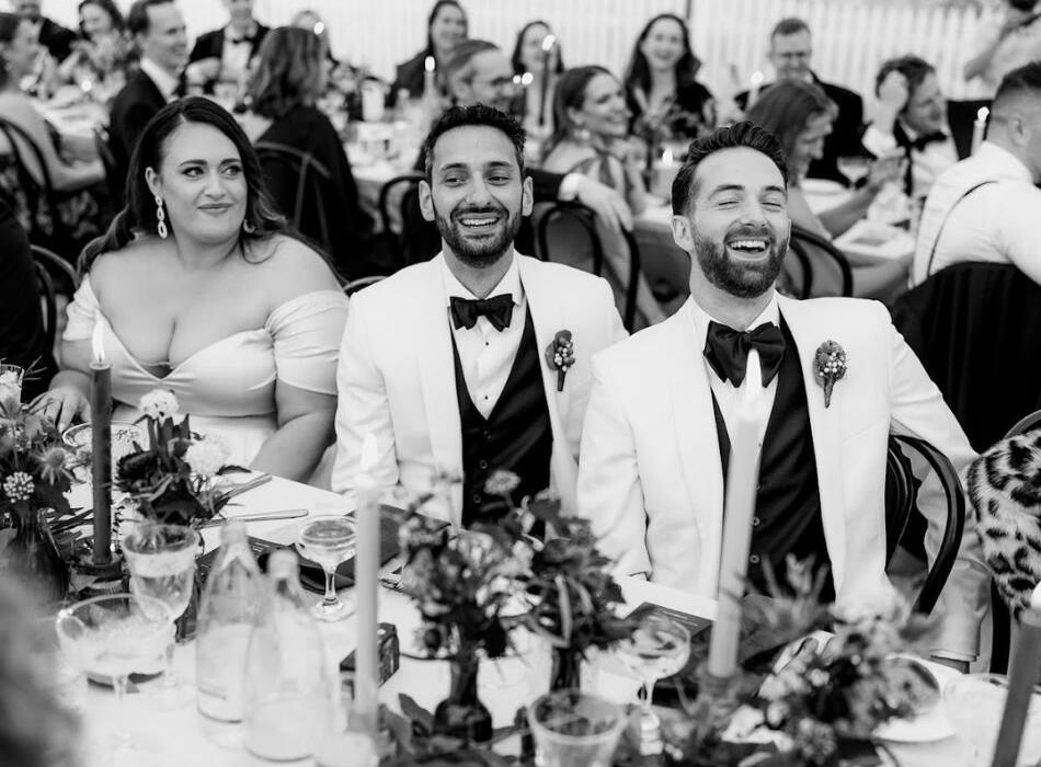 Couple Laughing at Wedding Reception Table